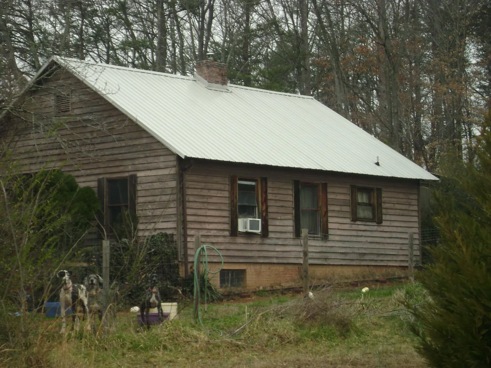 White metal roof on an old wood sided farmhouse, from a Metal Roof Installation job in Olney